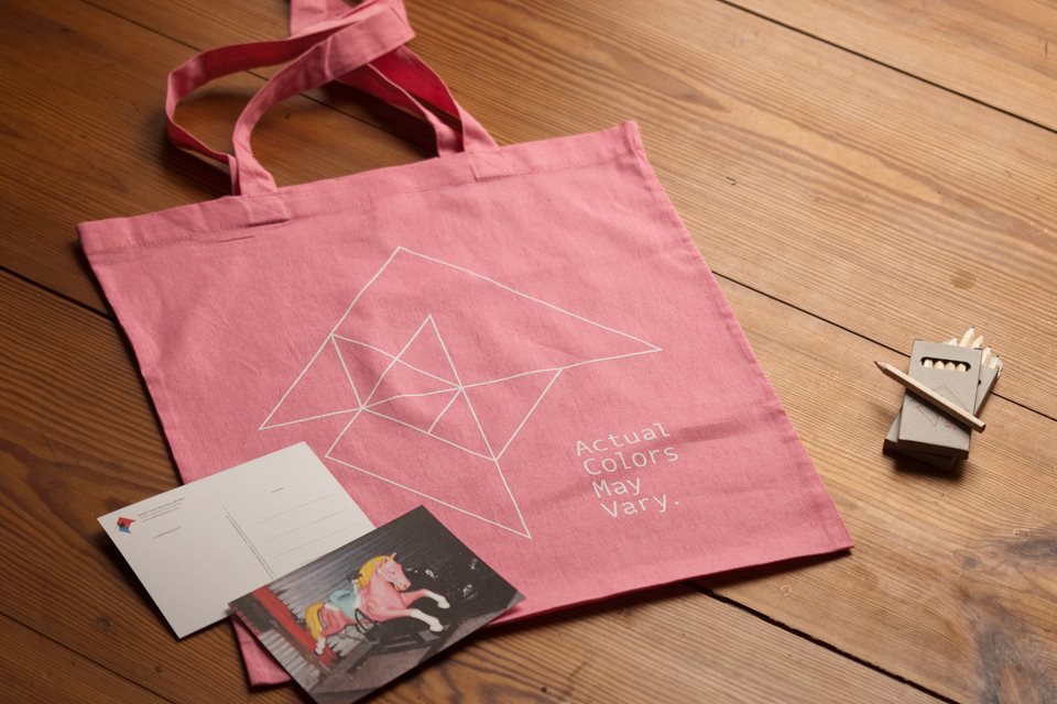 ACMV's screen printed tote bags, postcards feat. a photo by Maxwell Anderson, and hand-signed pencils